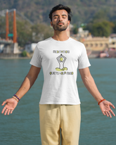 Man wearing a t-shirt with 'Meditation quiets your mind' design by a body of water.